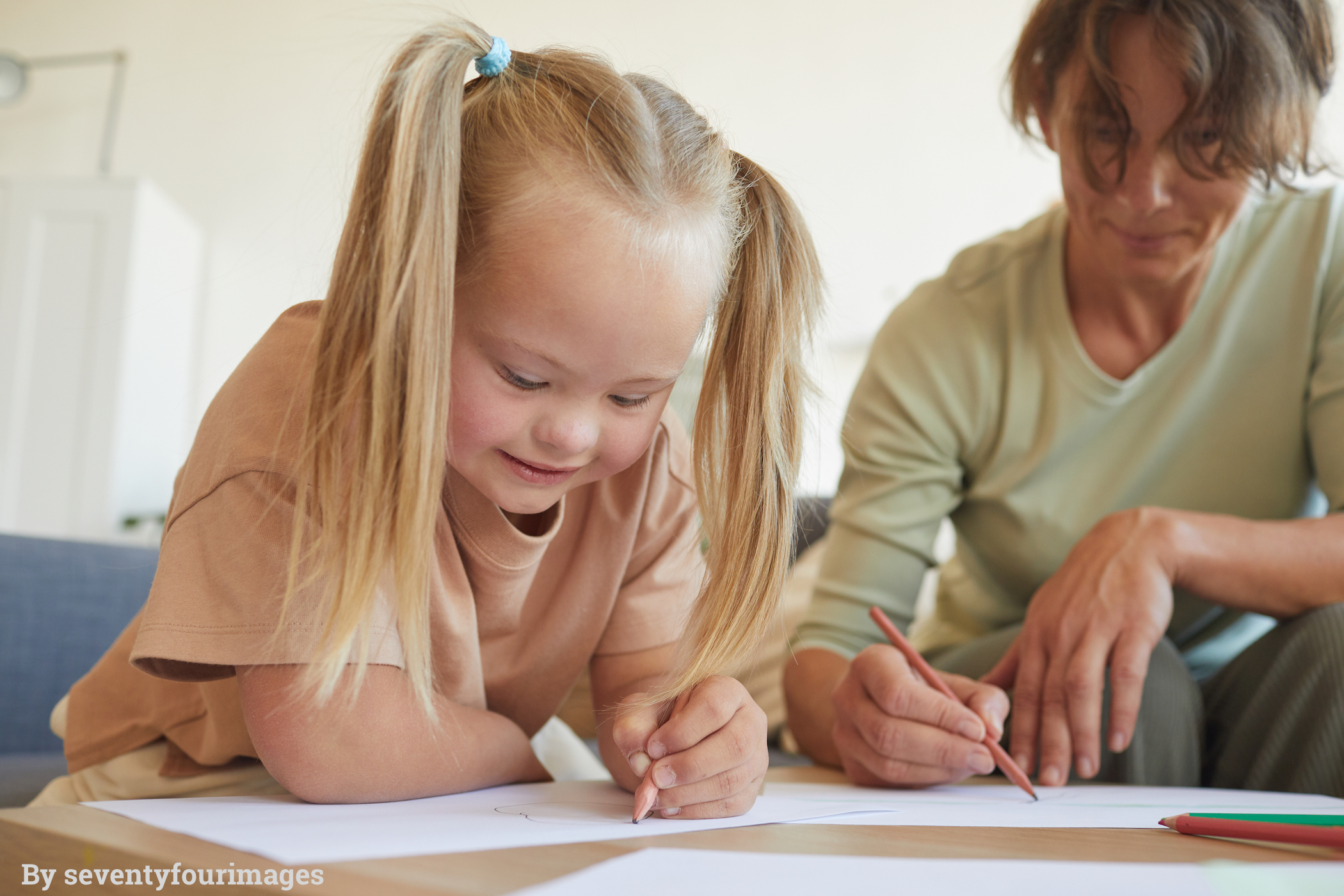 smiling-girl-with-down-syndrome-drawing-S8LSZWQ