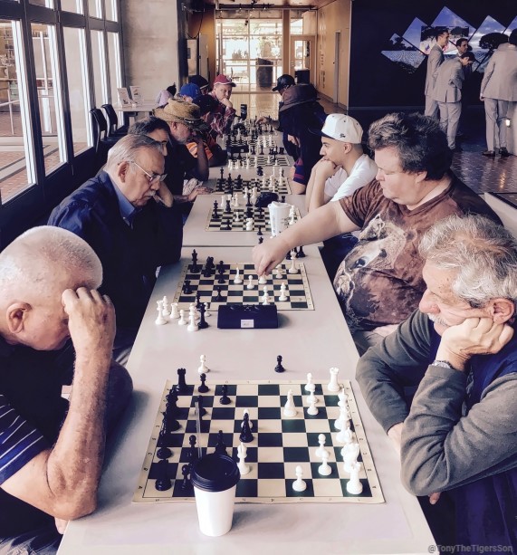 “Row-of-tables-with-multiple-chess-matches"