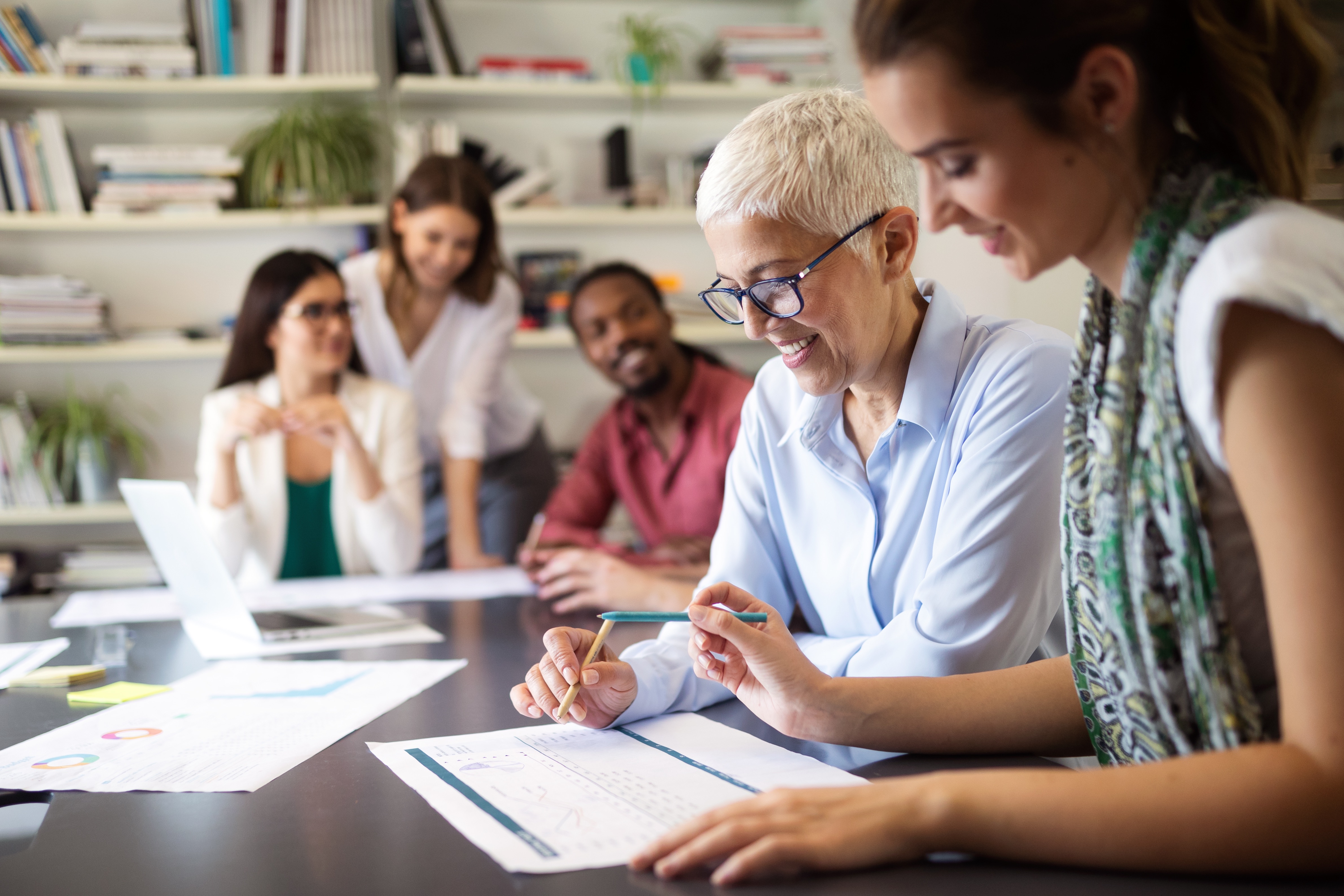 People-in-office-happily-looking-over-paperwork