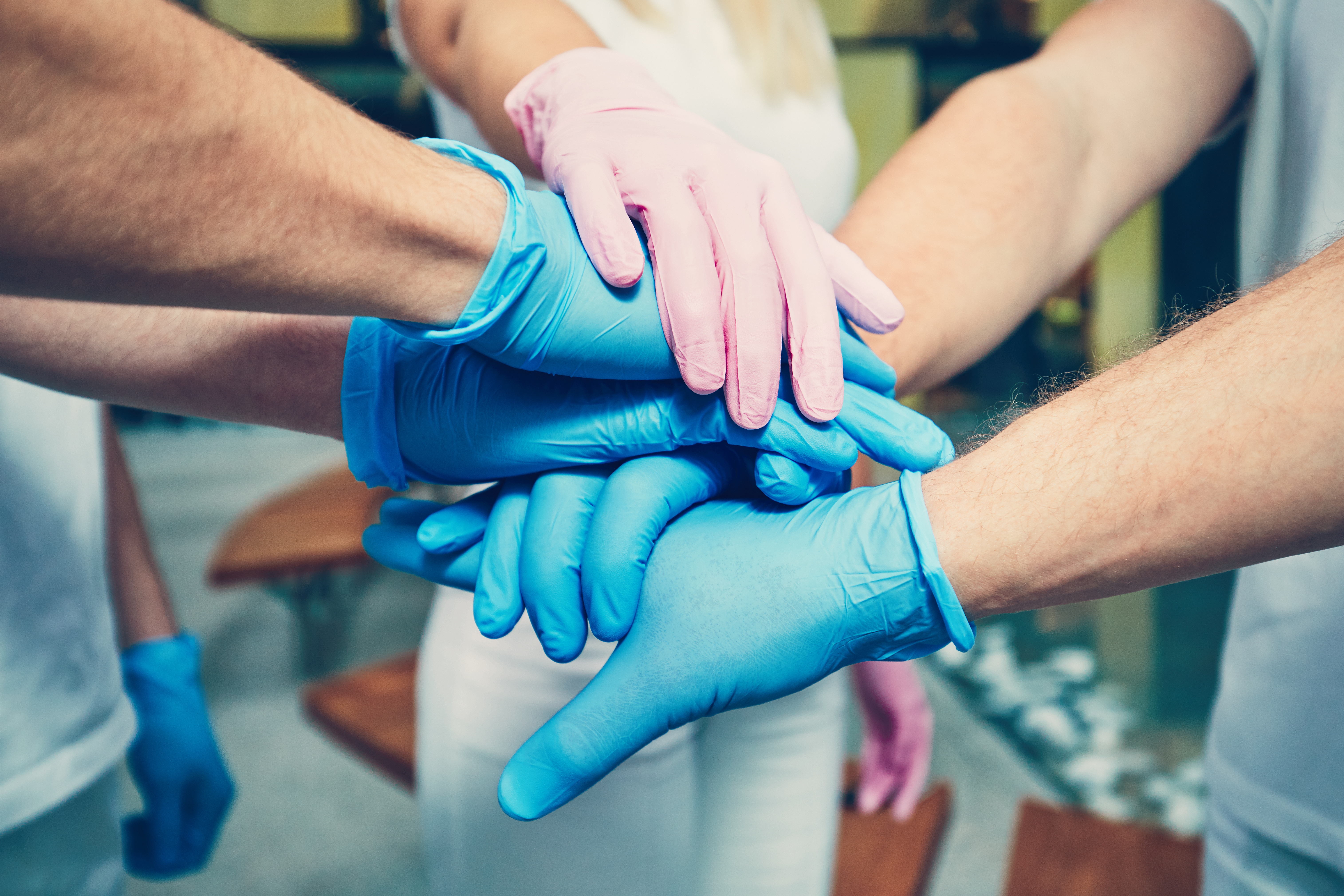 medical-staff-joining-hands-as-team