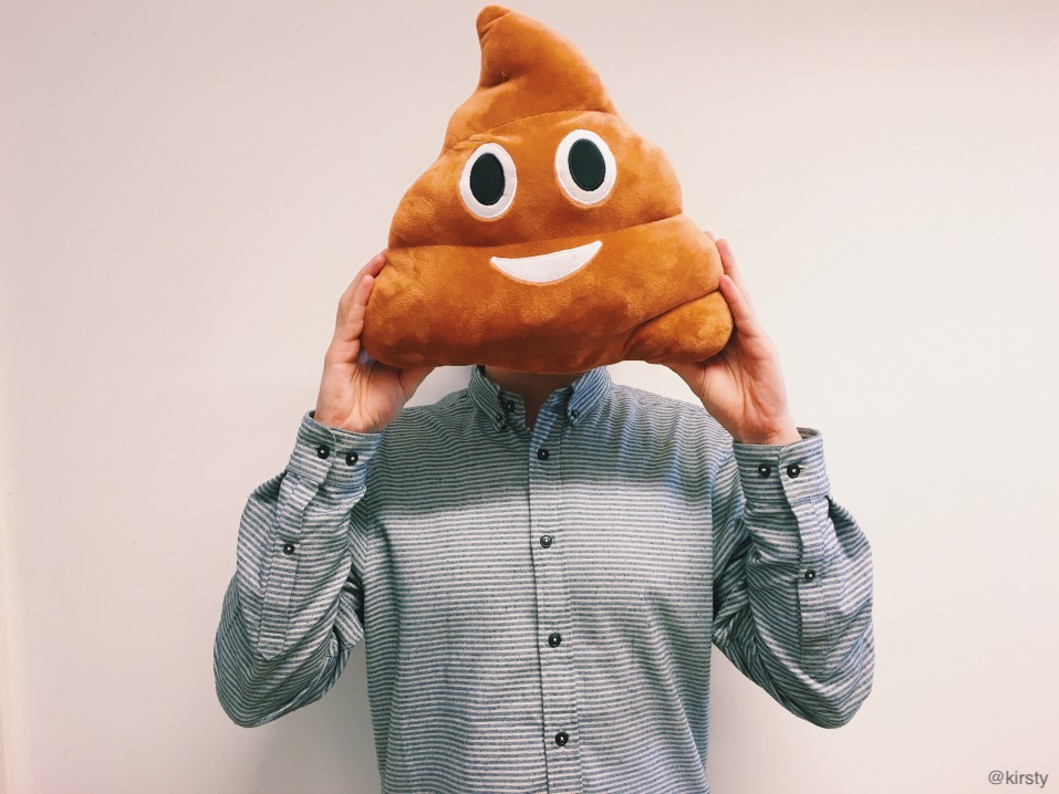 Man holding emoji symbol for soft-serve ice cream pillow in front of his head for a laugh