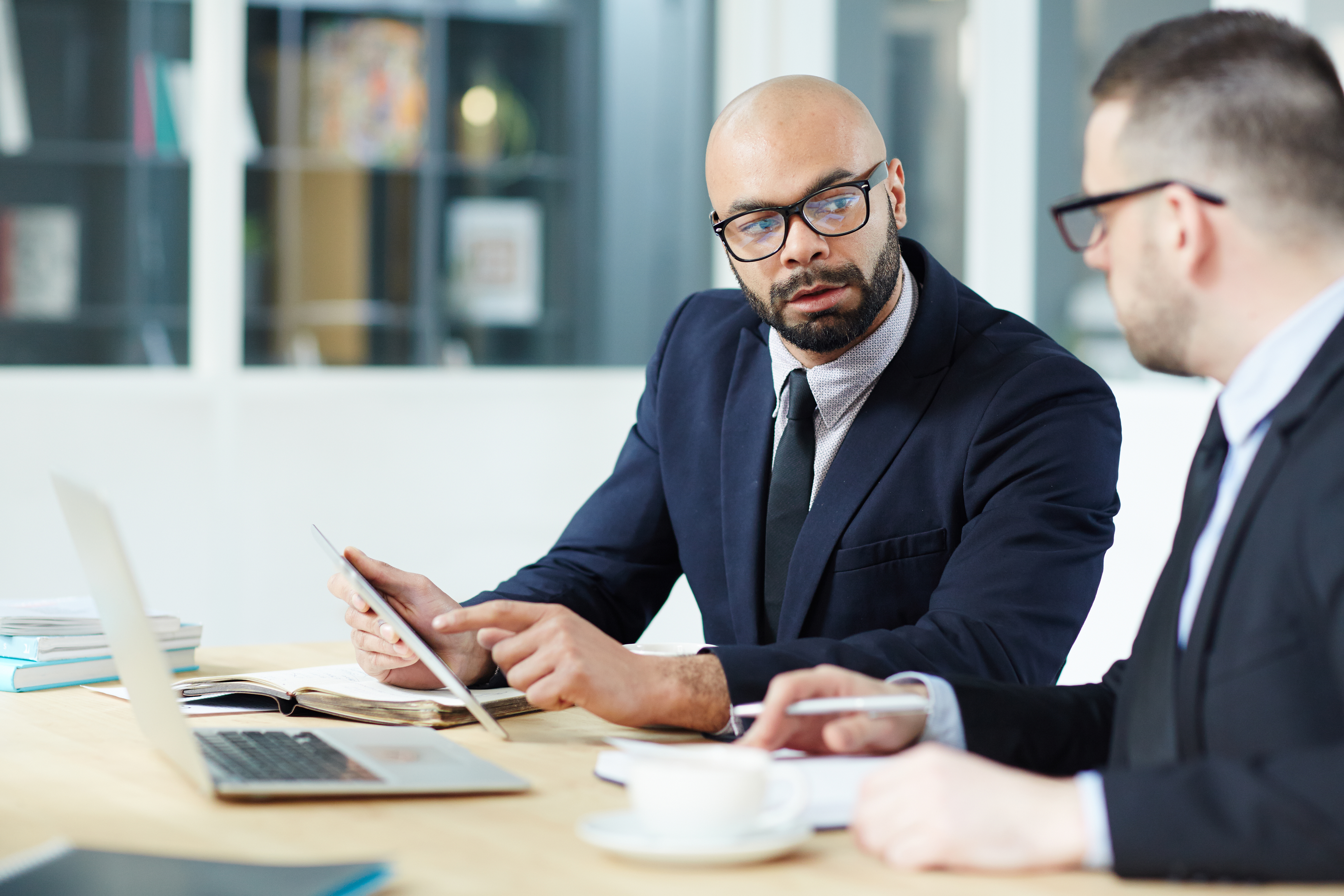 Man pointing at tablet with another man