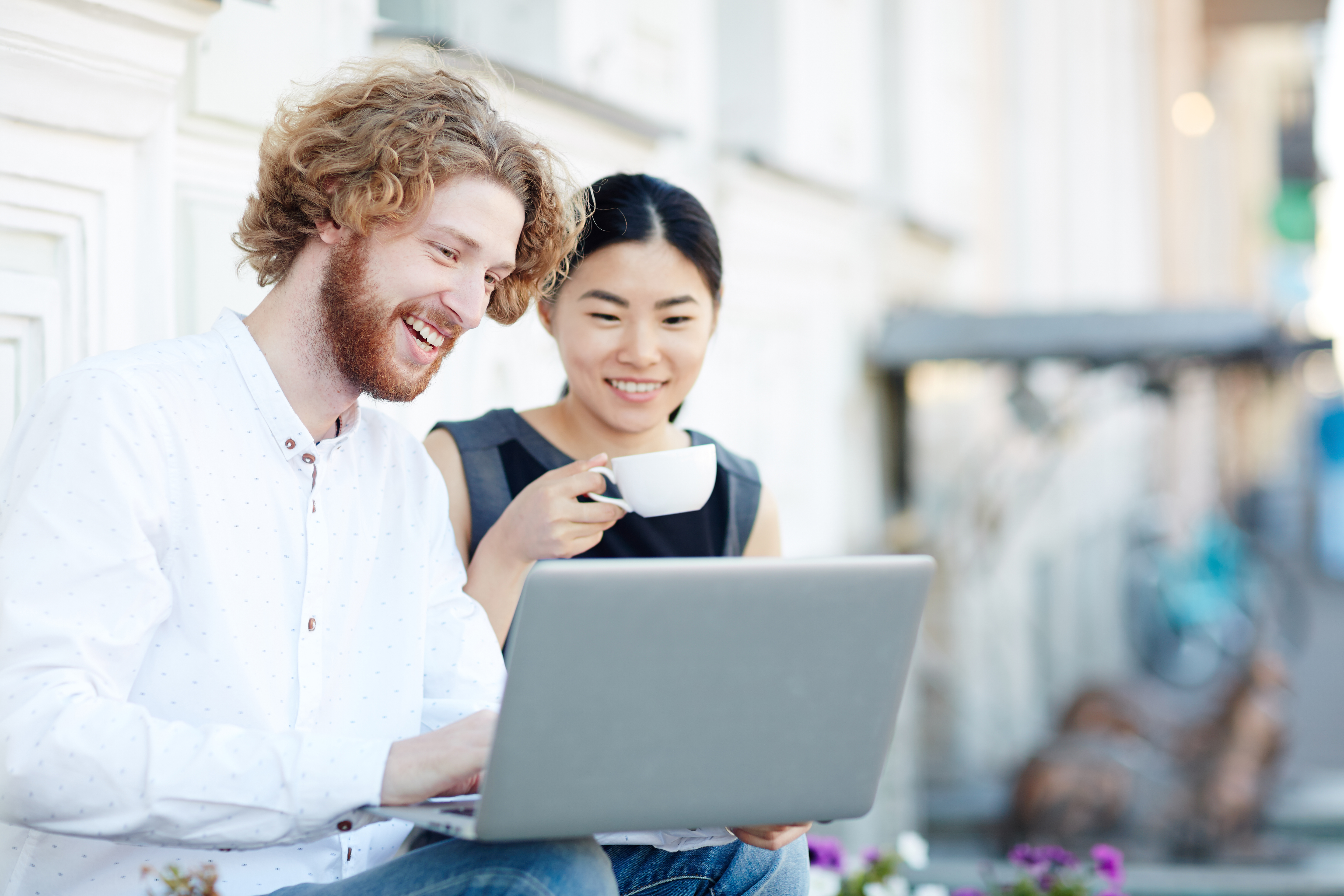 Two people talking looking at computer